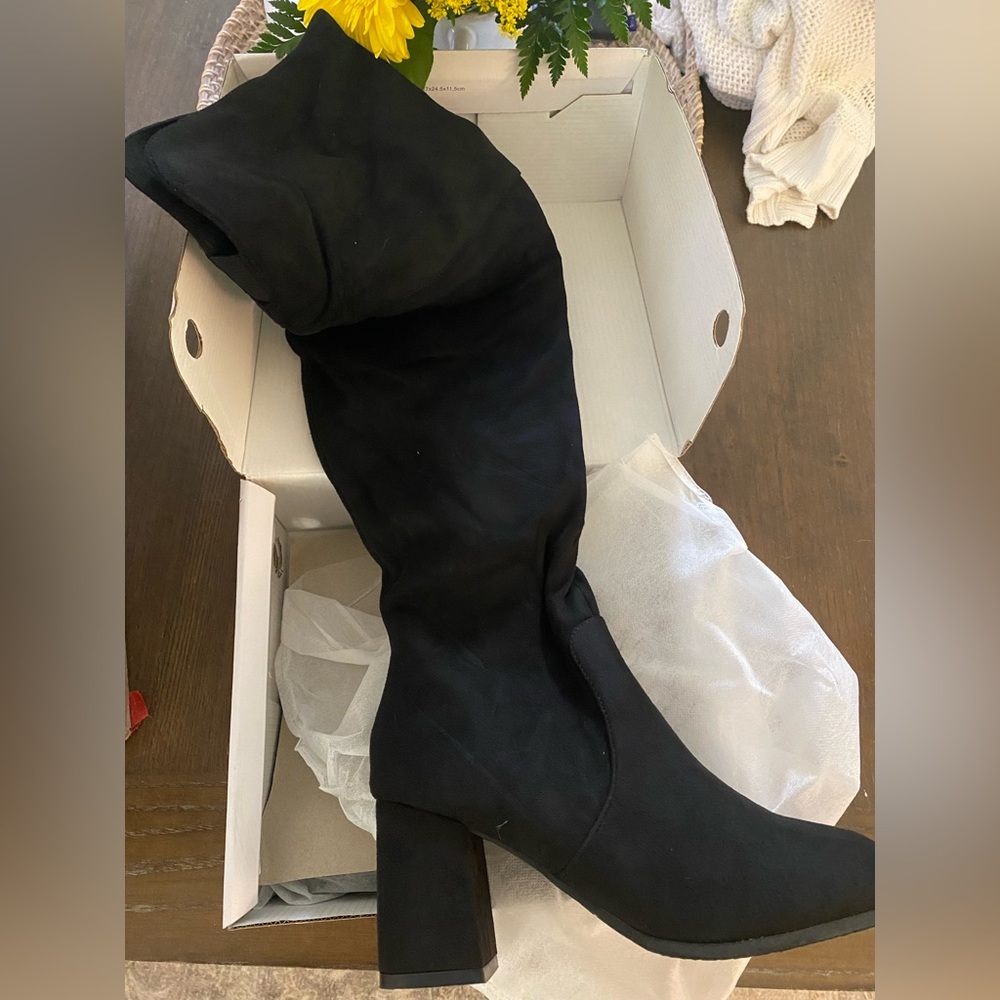 Brand new thigh, high black suede boots. Never worn size 9